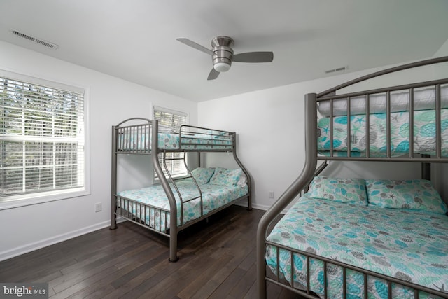 bedroom with visible vents, ceiling fan, baseboards, and wood-type flooring