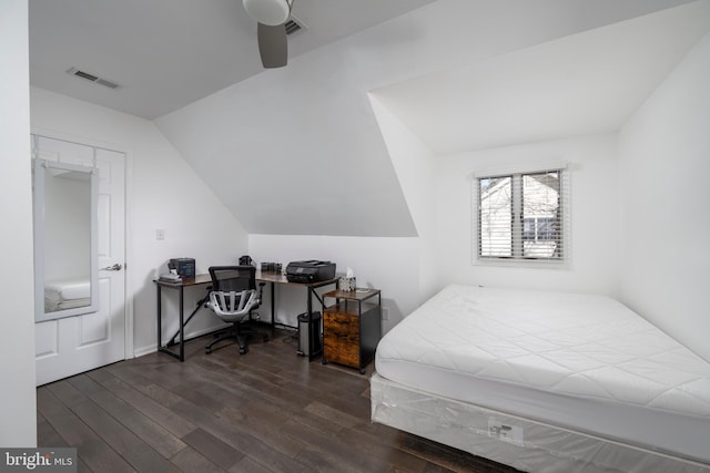 bedroom with dark wood-style floors, visible vents, and lofted ceiling