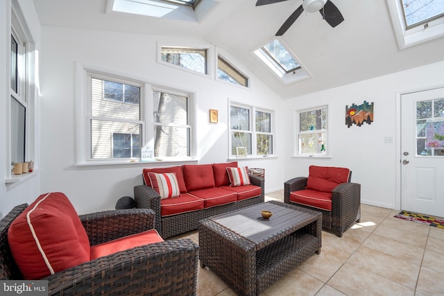 sunroom / solarium featuring lofted ceiling with skylight, plenty of natural light, and a ceiling fan