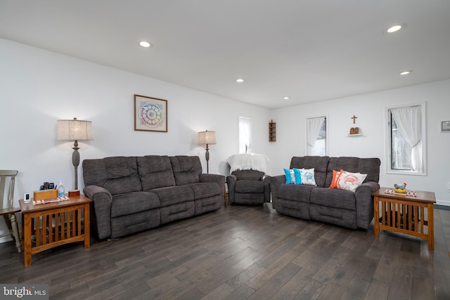 living room with dark wood finished floors and recessed lighting