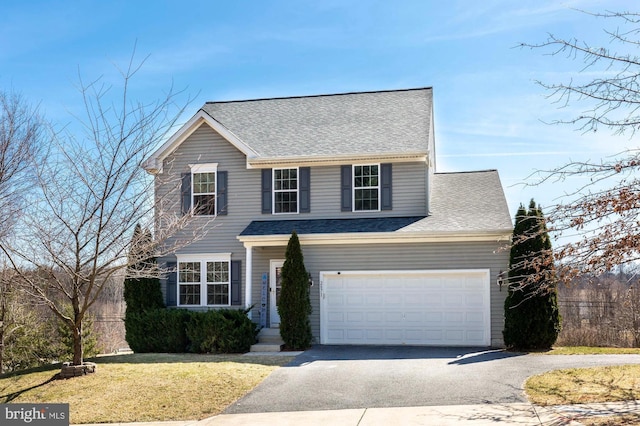 traditional-style house featuring a front yard, driveway, and roof with shingles