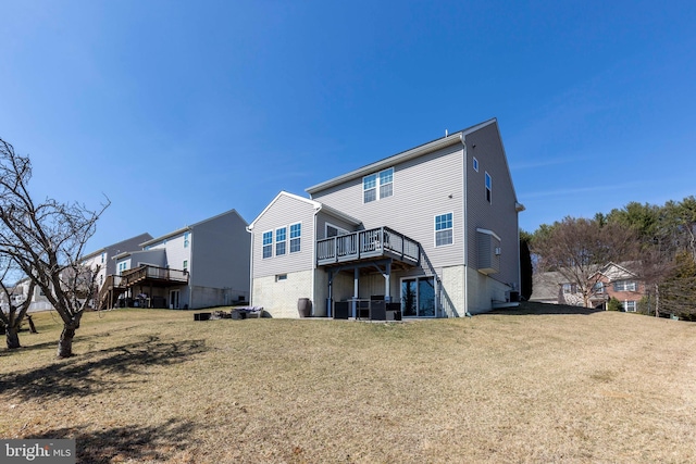 back of property featuring a residential view, a lawn, and a wooden deck