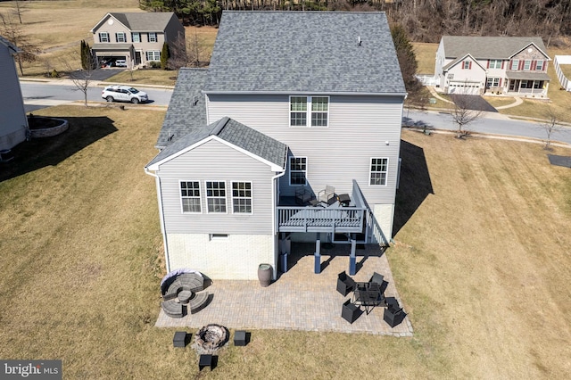 back of house with a yard, a wooden deck, a patio, and a shingled roof