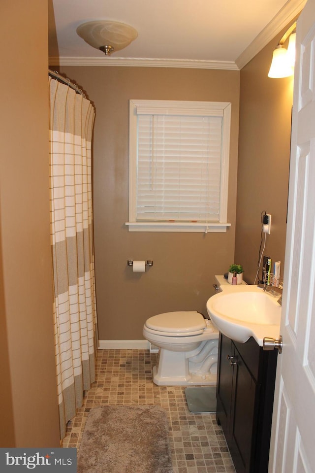 bathroom with toilet, vanity, baseboards, and ornamental molding