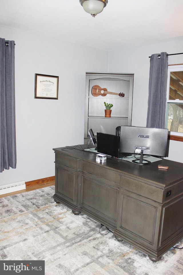 office space with baseboards and a baseboard radiator