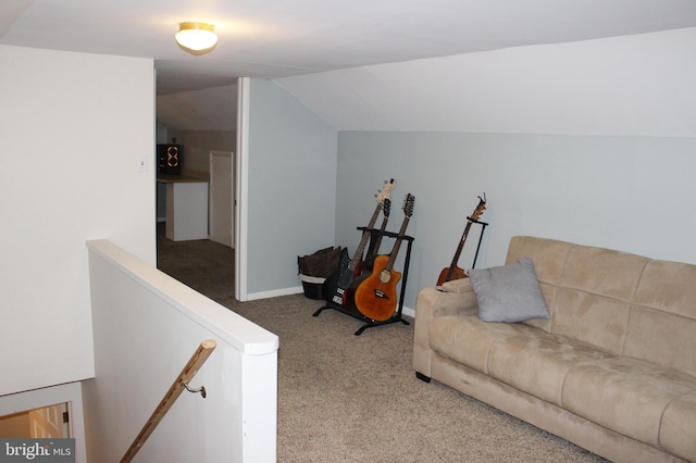 carpeted living area featuring lofted ceiling and baseboards