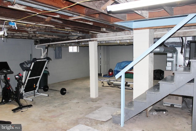 basement with electric panel and stairway