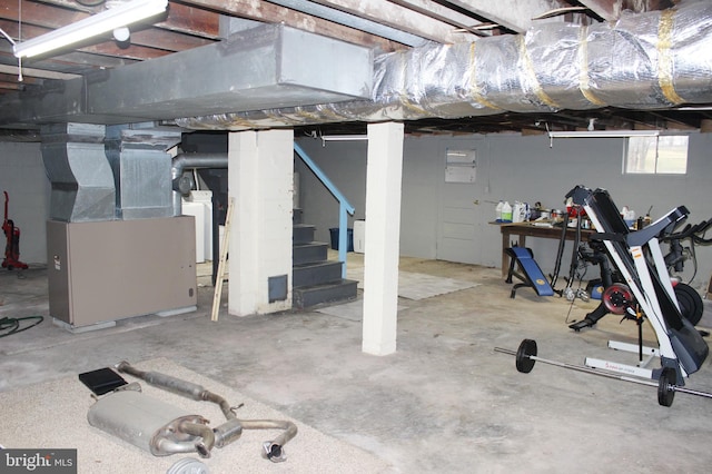 basement with heating unit, washer / clothes dryer, and stairs