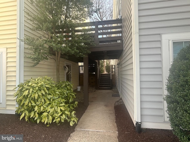 view of side of home with stairway and a wooden deck