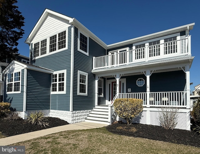 view of front facade with a balcony and covered porch