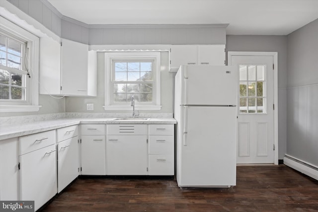 kitchen with white cabinetry, dark wood finished floors, a sink, and freestanding refrigerator