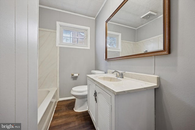 bathroom with visible vents, toilet, ornamental molding, wood finished floors, and vanity