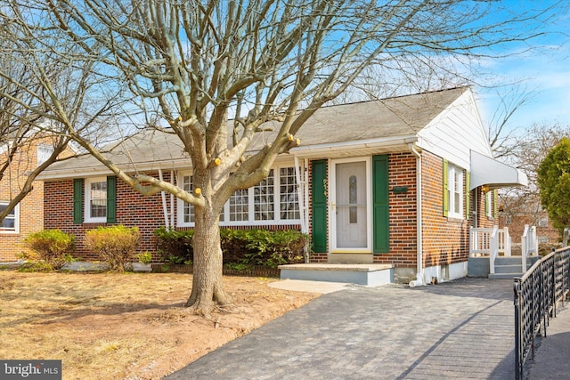 ranch-style home featuring brick siding