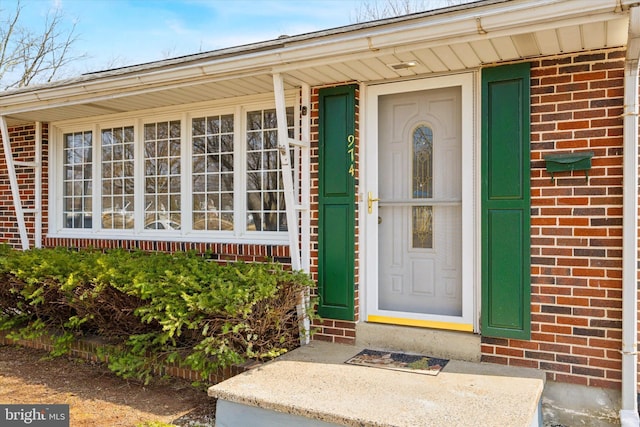 property entrance with brick siding