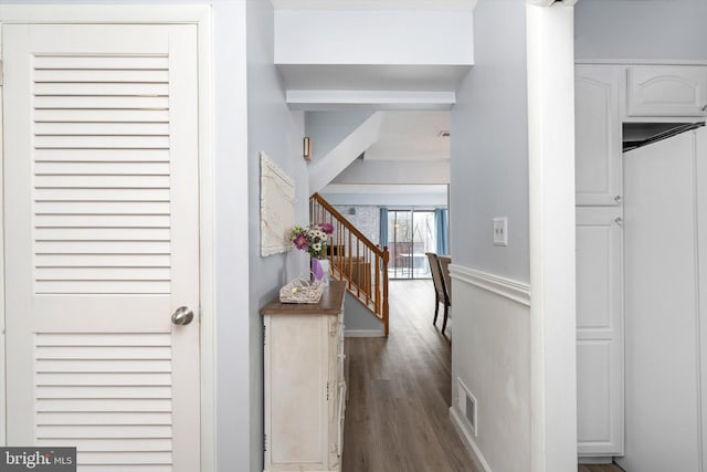 hall featuring visible vents and wood finished floors