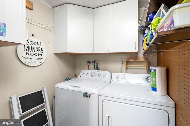 washroom featuring washer and dryer and cabinet space