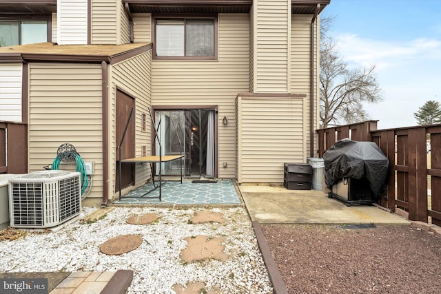 rear view of property featuring cooling unit, fence, and a patio area