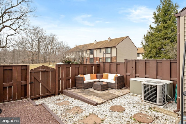 view of patio / terrace with central AC unit, a gate, and fence