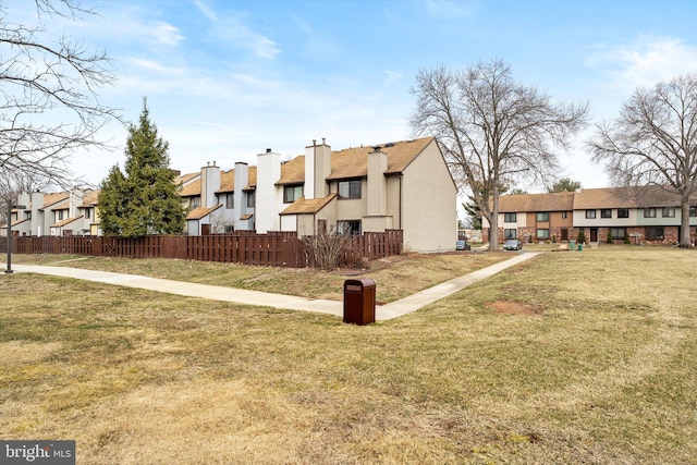 exterior space featuring a yard, fence, and a residential view