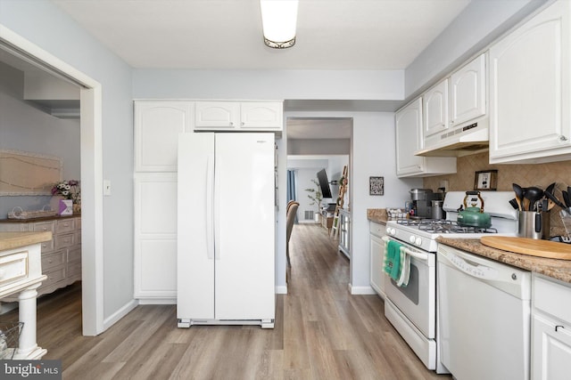 kitchen with white appliances, baseboards, light wood-style floors, under cabinet range hood, and white cabinetry