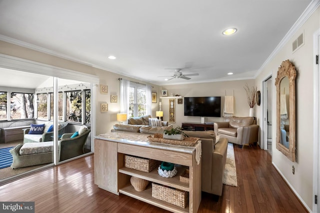 living room with dark wood-style floors, ornamental molding, visible vents, and recessed lighting