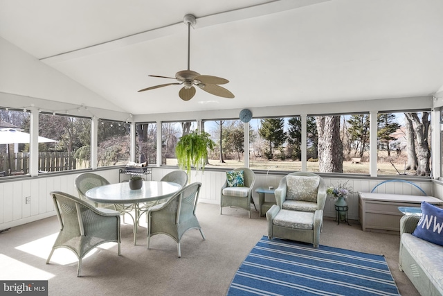 sunroom / solarium with a healthy amount of sunlight, vaulted ceiling, and ceiling fan