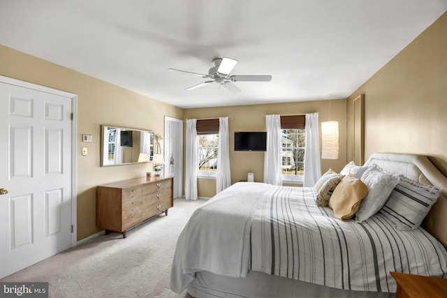 bedroom featuring ceiling fan and light colored carpet