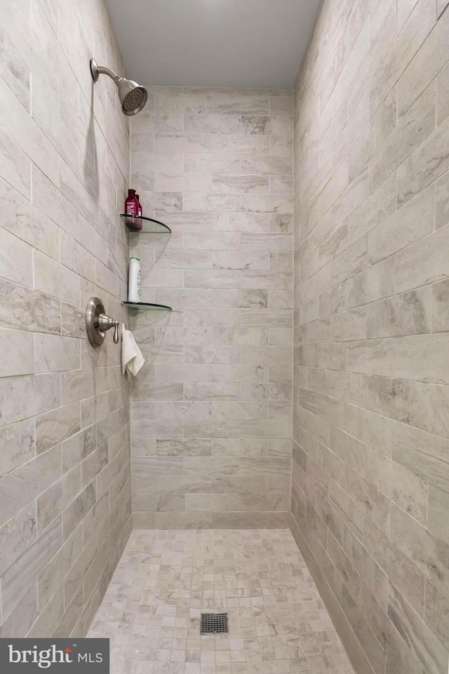 bathroom with tiled shower