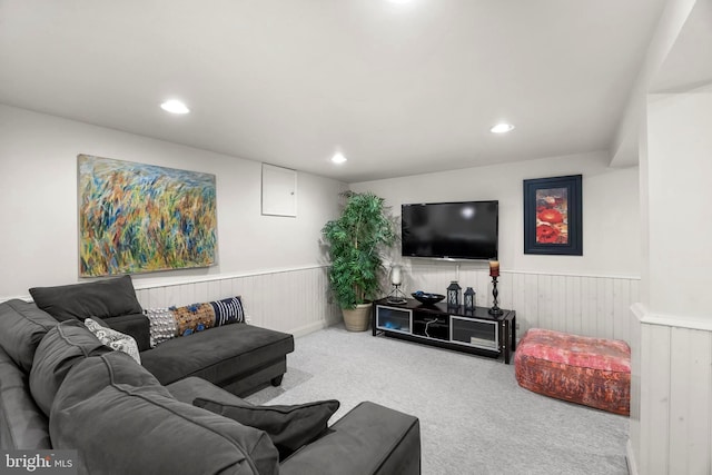 living room featuring carpet floors, recessed lighting, and a wainscoted wall