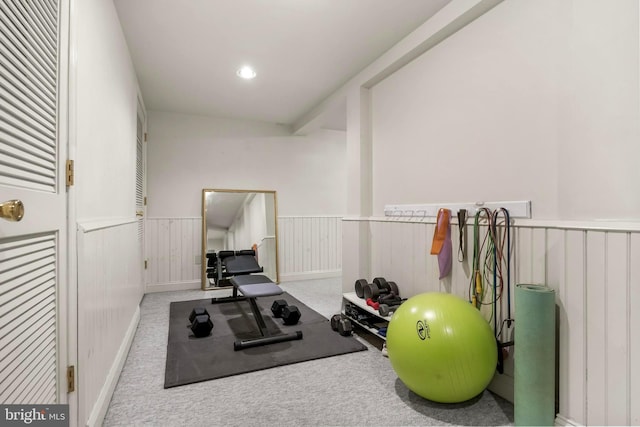 exercise area with a wainscoted wall, carpet, and recessed lighting