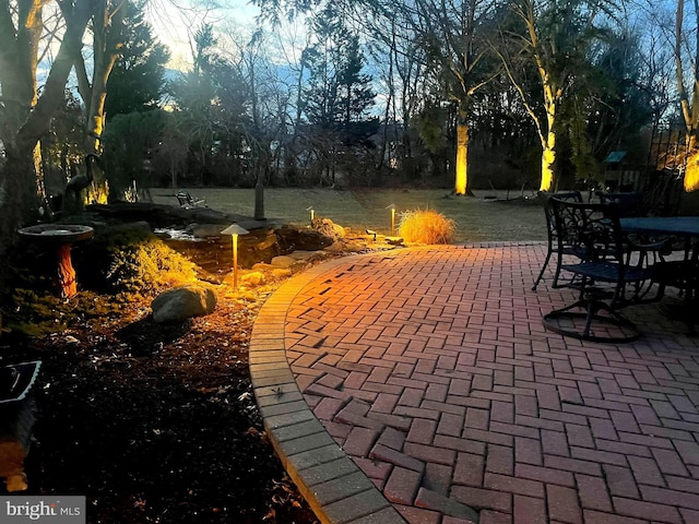 view of property's community featuring a patio and outdoor dining area