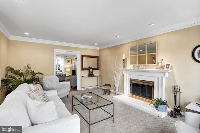 living room with a fireplace, recessed lighting, ornamental molding, carpet flooring, and baseboards