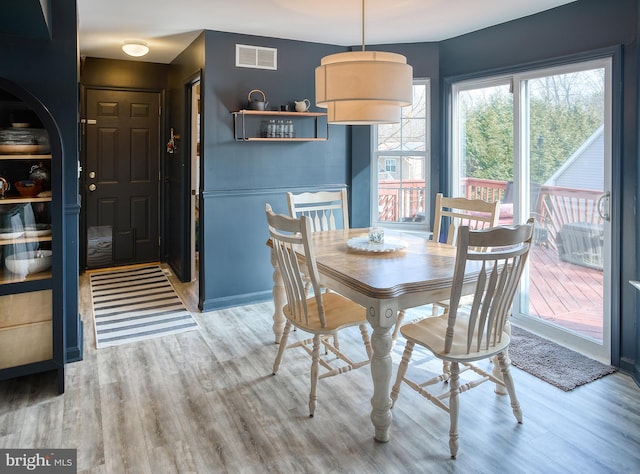 dining area featuring visible vents and wood finished floors