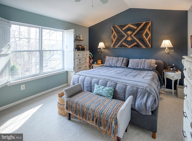 carpeted bedroom with vaulted ceiling, baseboards, and ceiling fan