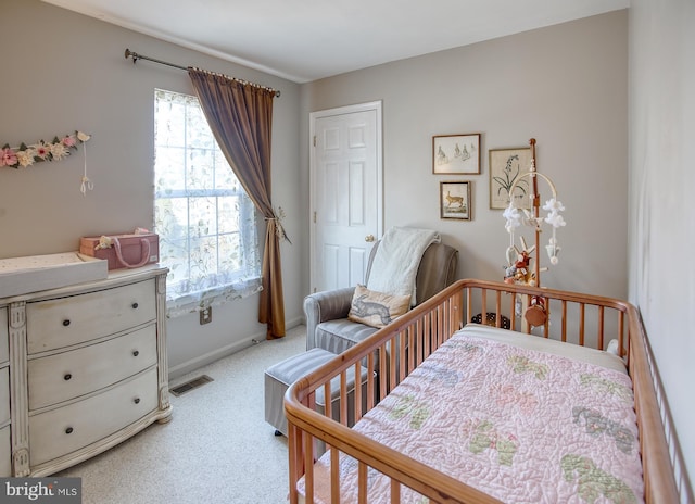 bedroom featuring baseboards, multiple windows, visible vents, and light colored carpet