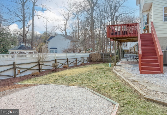 view of yard featuring a fenced backyard, a patio, stairway, and a wooden deck