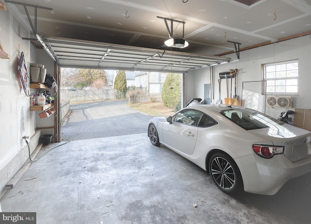 garage featuring electric panel and a garage door opener