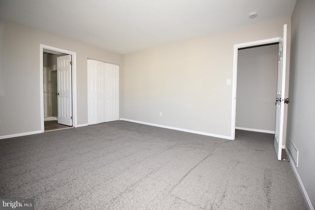 unfurnished bedroom with carpet, a closet, visible vents, and baseboards