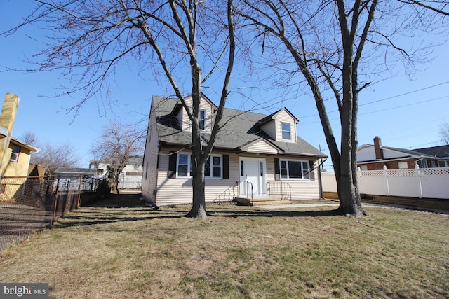 cape cod house featuring a front yard and fence