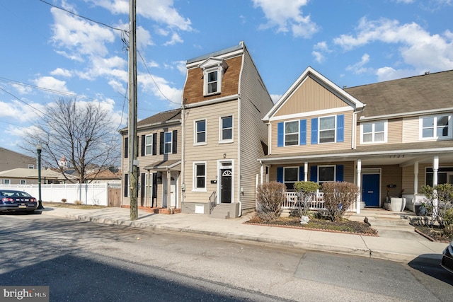 multi unit property featuring entry steps, a porch, and fence