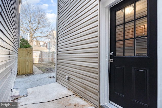 view of exterior entry featuring fence