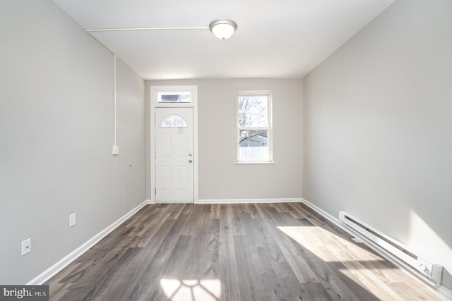 entrance foyer with a baseboard radiator, baseboards, and wood finished floors