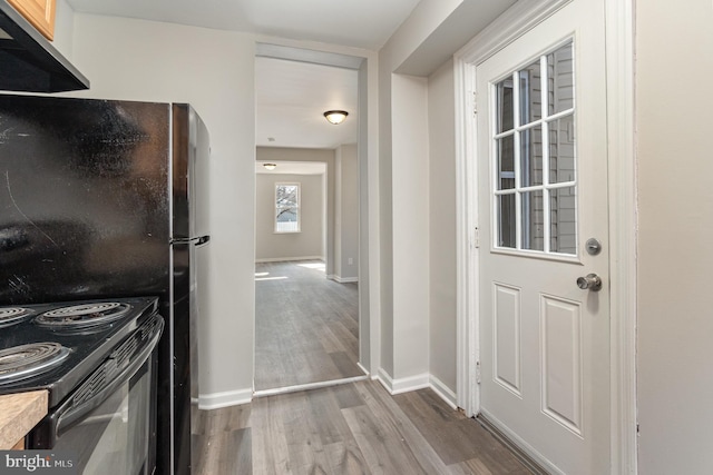 interior space featuring baseboards and wood finished floors