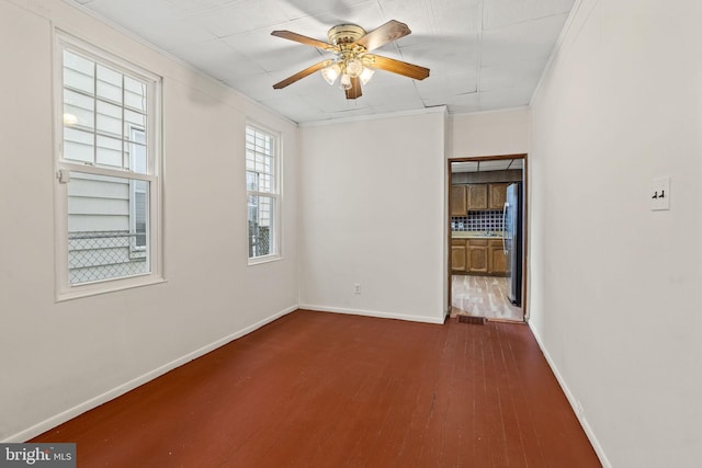 4513 E Stiles St, Philadelphia, PA 19124 - empty room featuring baseboards, crown molding, a ceiling fan, and dark wood-style flooring
