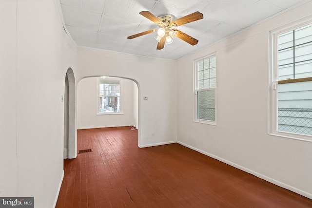 4513 E Stiles St, Philadelphia, PA 19124 - empty room featuring baseboards, visible vents, arched walkways, dark wood-style flooring, and crown molding