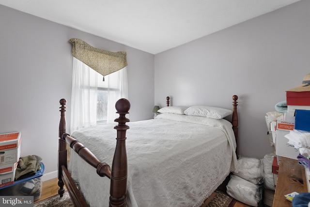 bedroom featuring baseboards and wood finished floors
