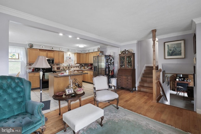 living area featuring light wood-style floors and ornamental molding