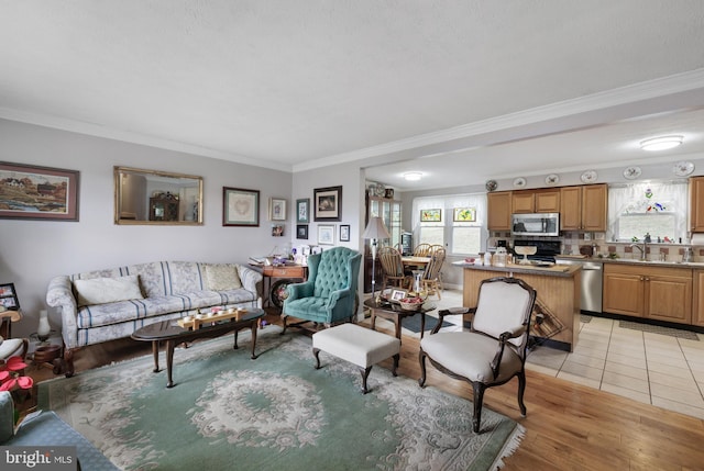 living room with light wood-style flooring and crown molding