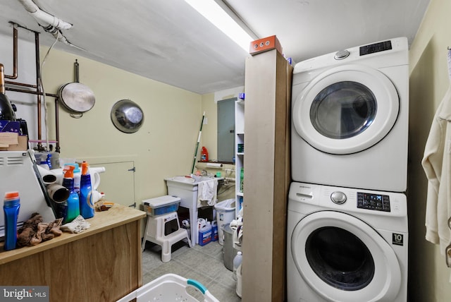 laundry area with stacked washer and clothes dryer and laundry area