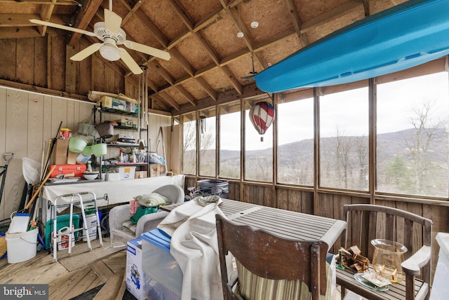 sunroom / solarium featuring a mountain view, a ceiling fan, and lofted ceiling
